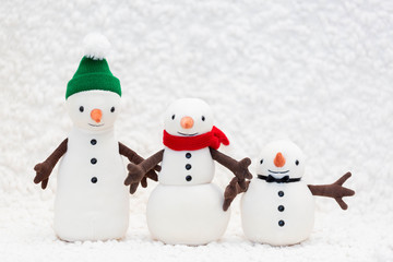 Toy snowman family on white background