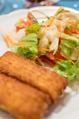 Potato croquette filled with cheese and herbs served with fresh green salad, tomatoes and pepper