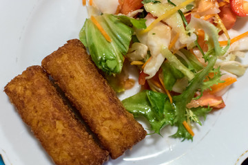 Potato croquette filled with cheese and herbs served with fresh green salad, tomatoes and pepper