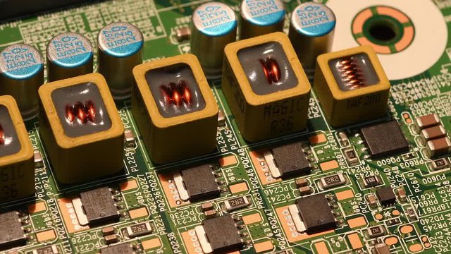 Detail on Electronic components on modern pc motherboard with microprocessors and capacitors. 4K UHD Video
