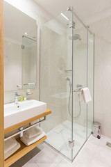 Interior of a luxury hotel bathroom with glass shower cabin