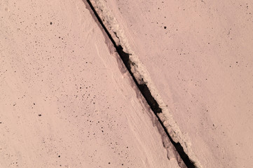 The pink concrete wall. The wall is textured.