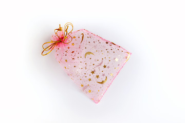 Obraz na płótnie Canvas This is a beautiful gift transparent pink and gold empty packing bag on a white background. Suitable for packaging jewelry, cosmetics, small gifts and surprises.