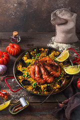 Traditional paella with shrimps, calamari and mussels in paellara pan