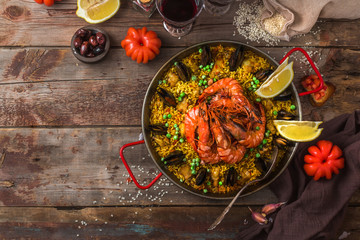 Large pan of paella with seafood and vegetables, copy space