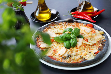 Black pizza, tasty pizza on black dough.
