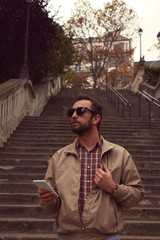 Handsome man using cellphone while enjoying in Paris.
