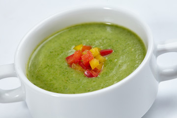 green cream soup in the white bowl