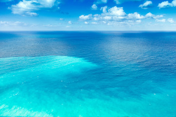 Clear sea with several shades of blue under azure sky