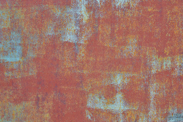 rusty metal wall with traces of old blue paint