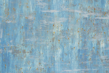 metal old wall painted with white and blue paint with traces of rust