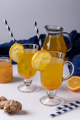 Homemade invigorating drink with lemon, ginger, honey and turmeric on a white background, Vertical orientation