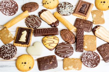 Fototapeta na wymiar Many Different Biscuits on a White Wooden Background