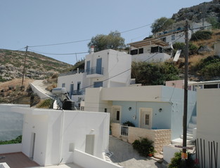 Fototapeta premium Walk through the narrow streets of the town of Matala. The architecture of the Greek houses.
