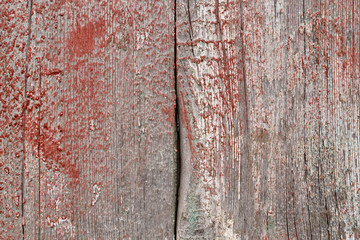 texture of an old wooden table with strokes of red, white and green paint