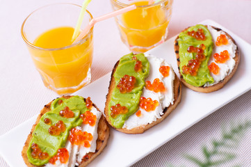 Toast with caviar and some orange juice