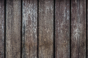 Photo of very old wooden planks, on which there were faint traces of white paint under the influence of time and weather conditions