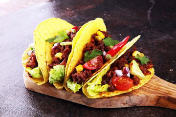 Mexican tacos with beef, tomatoes, avocado, chilli and onions. Handmade tortilla with pork