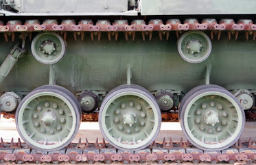 Close-up cut-out side view of an old decommissioned Patton tank showing the underbody with some wheels and part of the track chain