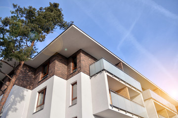 Modern apartment buildings on a sunny day with a blue sky. Facade of a modern apartment building.Glass surface with sunlight.