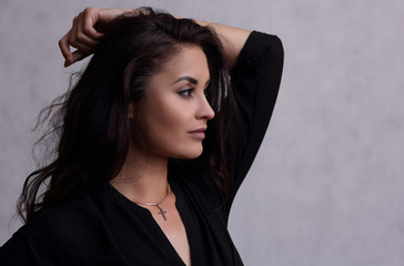 Portrait in profile of a beautiful young brunette woman