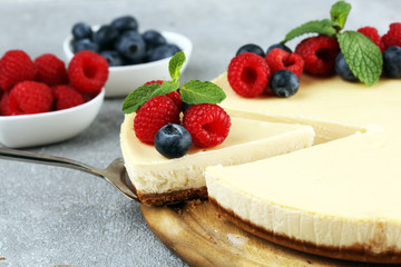 Homemade cheesecake with fresh raspberries and mint for dessert - healthy organic summer dessert pie cheesecake. Vanilla Cheese Cake for dessert