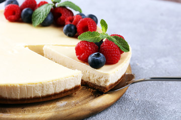 Homemade cheesecake with fresh raspberries and mint for dessert - healthy organic summer dessert pie cheesecake. Vanilla Cheese Cake for dessert