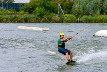 Teenager wakeboarding on a lake - Brwinow, Masovia, Poland