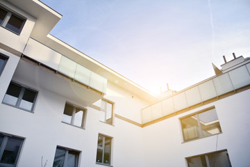 Modern apartment buildings on a sunny day with a blue sky. Facade of a modern apartment building.Glass surface with sunlight.