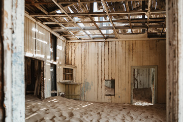 desert sand has invaded and taken over these rooms in Kolmanskoppe, Namibia