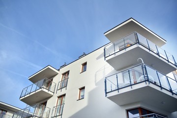 Modern apartment buildings on a sunny day with a blue sky. Facade of a modern apartment building.Glass surface with sunlight.