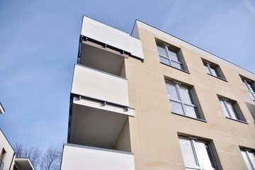 Modern apartment buildings on a sunny day with a blue sky. Facade of a modern apartment building.Glass surface with sunlight.