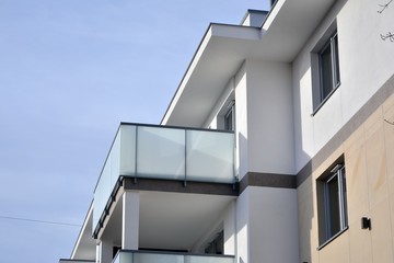 Modern apartment buildings on a sunny day with a blue sky. Facade of a modern apartment building.Glass surface with sunlight.