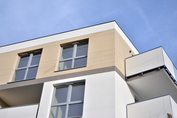 Modern apartment buildings on a sunny day with a blue sky. Facade of a modern apartment building.Glass surface with sunlight.