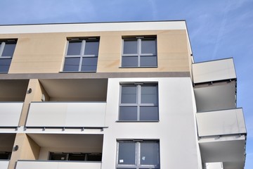 Modern apartment buildings on a sunny day with a blue sky. Facade of a modern apartment building.Glass surface with sunlight.