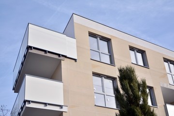 Modern apartment buildings on a sunny day with a blue sky. Facade of a modern apartment building.Glass surface with sunlight.