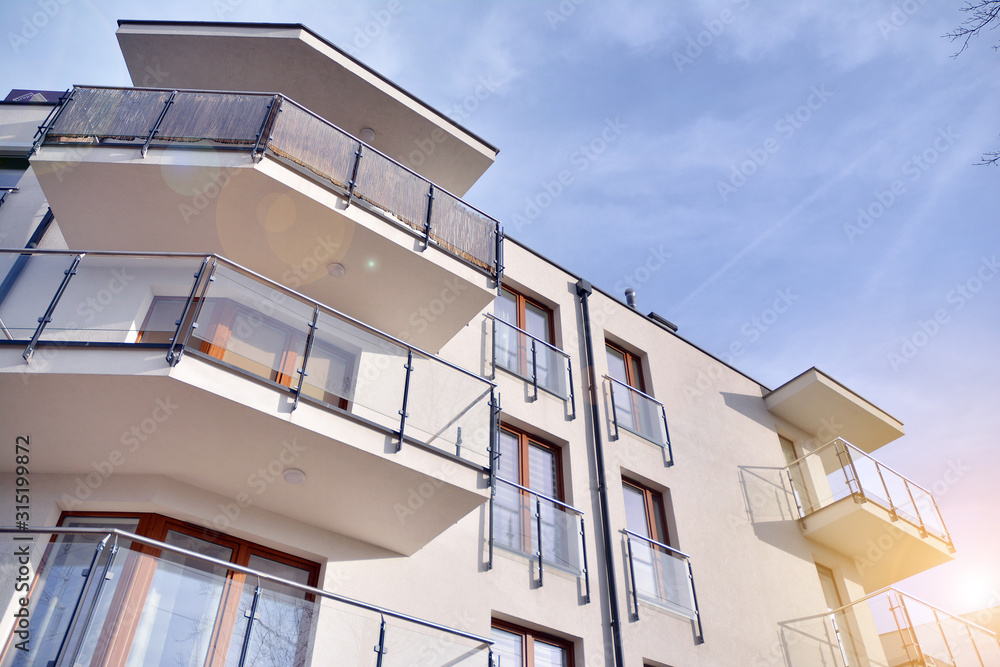 Wall mural modern apartment buildings on a sunny day with a blue sky. facade of a modern apartment building.gla