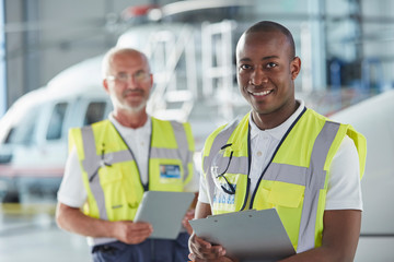 Portrait smiling air traffic control ground crew worker with clipboard