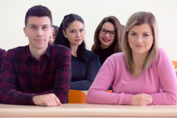 Group of  young multietchnic economy students analyzing company annual financial report balance and prepairing for test. Concept of economy, education. Looking at camera.