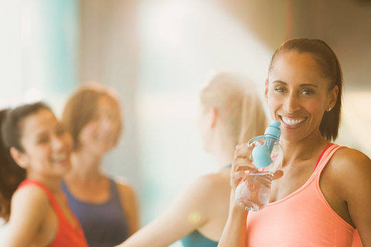 Portrait Smiling Woman Drinking Water In Exercise Class Gym Studio