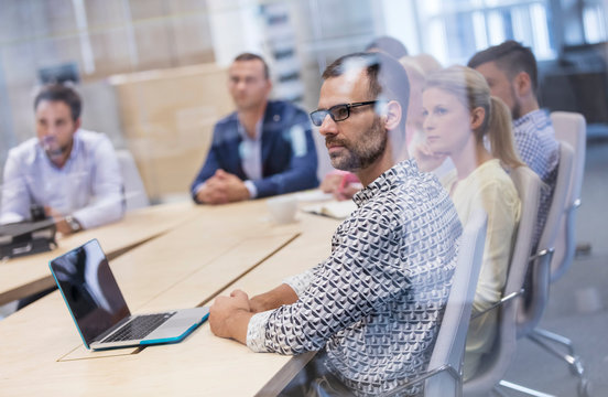 Business people listening in conference room meeting