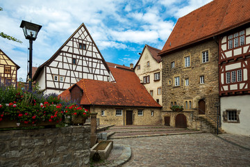 Historic, medieval half-timbered houses. The old German city of Bad Wimpfen in Baden-W rttemberg, Germany. Summer photo on a sunny day against a bright blue sky