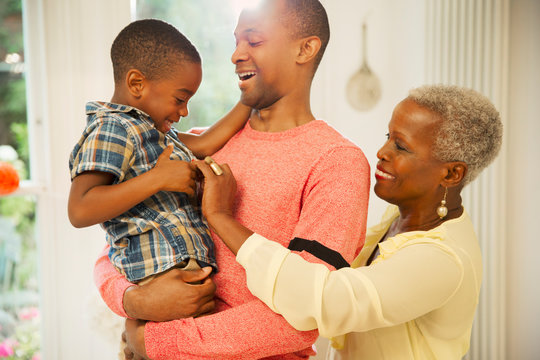 Affectionate multi-generation family hugging