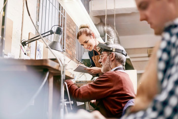 Jeweler and apprentice working in workshop