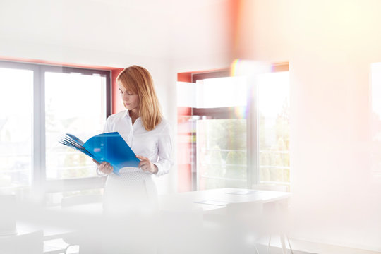 Businesswoman reviewing paperwork in conference room