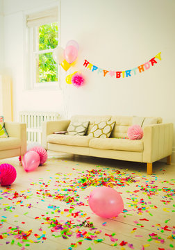 Birthday Sign, Balloons And Confetti In Living Room