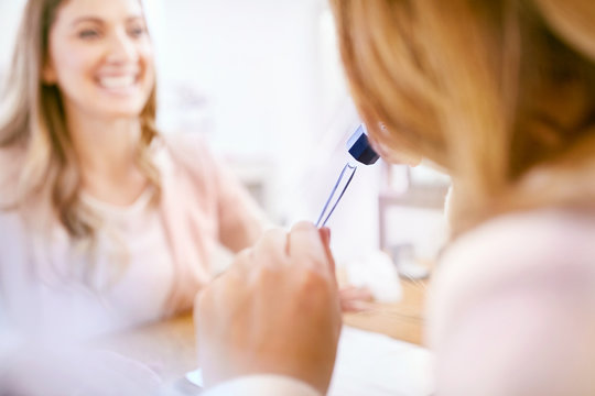 Jeweler helping woman shopping using loupe
