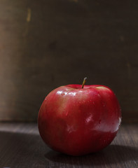 One red apple on a dark background