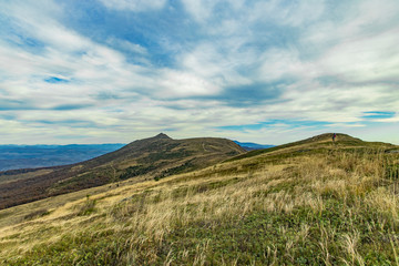 highland mountain ridge scenery landscape view spring time cold weather with cloudy blue sky horizon background