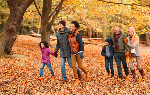 Multi-generation Family Walking In Autumn Park